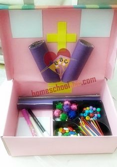 a pink box filled with lots of crafting supplies