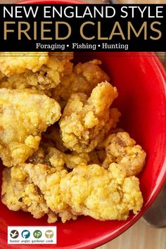 a red bowl filled with fried clams on top of a wooden table