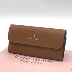 Brand New With Tag Kate Spade Rosie Large Flap Wallet Measurements 7.8" W X 4" H Color: Warm Gingerbread Features Metal Pinmount With Spade Logo Dust Bag Included: No Materials Pebbled Leather Lining: Two Way Spade Jacquard Lining Imported Kate Spade Brown Rectangular Wallets, Kate Spade Brown Everyday Wallet, Kate Spade Clutch For Everyday Use, Everyday Beige Kate Spade Wallet, Kate Spade Beige Wallet, Beige Clutch With Interior Card Slots, Yellow Wallet, Spade Logo, Leather Phone Wallet