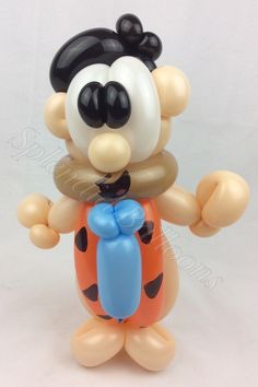 a mickey mouse figurine holding an orange and blue balloon