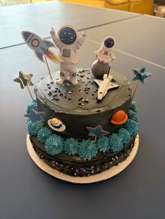 a birthday cake with an astronaut and rocket on top