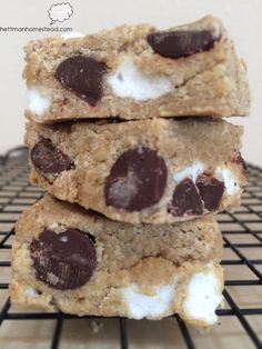 chocolate chip cookies and marshmallows are stacked on top of each other with the words, s'mores quest bars