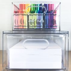 two clear boxes with colored crayons in them