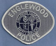 the badge for engwood police is shown on a blue background