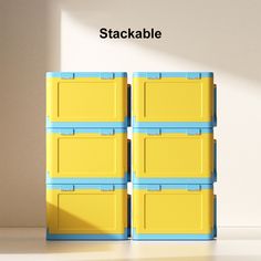 several yellow and blue boxes stacked on top of each other in front of a white wall