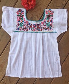 "Beautiful, elegant, comfortable, fresh and soft blouse With beautiful flower embroidered detailed work on the top and back Get the Boho & hippie style you like Perfect to wear with your favorite jeans You will love your unique one of a kind piece Is a MUST HAVE in you wardrobe Every blouse is individually handcrafted Color may vary on stitching as each blouse is unique Perfect for Fiestas Patrias Perfect gift idea **HAND WASH ONLY** MEASUREMENTS Small: Bust 32-34\" -- Length: 24\" Medium: B Summer Folk Peasant Top With Embroidered Sleeves, Bohemian Embroidered Relaxed Fit Blouse, Casual White Peasant Top For Festival, Summer Crew Neck Blouse With Floral Embroidery, Bohemian Embroidered Top With Floral Design For Spring, Spring Bohemian Embroidered Top With Floral Details, Bohemian Floral Embroidered Top For Spring, Spring Bohemian Crew Neck Blouse, Spring Peasant Top With Multicolor Geometric Embroidery