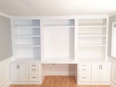 an empty room with built in cabinets and drawers on the wall, along with hard wood flooring