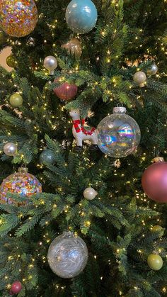 a christmas tree with ornaments and lights on it