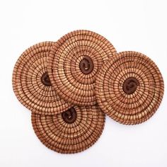 four woven coasters with brown buttons on them