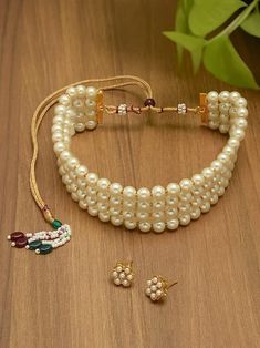 Enhance your traditional look with the Gold Tone Ethnic Multistrand Pearls Choker Necklace & Earring Set for Women. This elegant set is perfect for weddings, parties, and special occasions, offering a blend of tradition and modern style. It also makes an ideal gift for any cultural celebration. Pearls Choker, Indian Jewelry Sets, Cultural Celebration, Elegant Sets, Pearl Choker Necklace, Pearl Choker, Dress Jewelry, Ethnic Jewelry, Wedding Wear