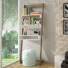 a white book shelf sitting next to a window filled with books and other items on top of a hard wood floor