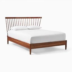 a bed with white sheets and wooden headboard on it's side, against a white background