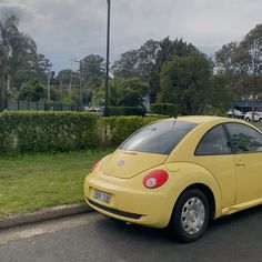 a yellow car is parked on the side of the road