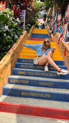 a woman is sitting on the stairs outside