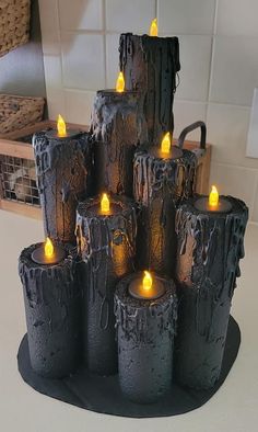 there are many lit candles in the shape of logs on the table next to a basket