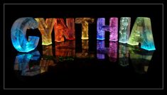 the word glythea spelled with glowing letters on a black background in bright colors