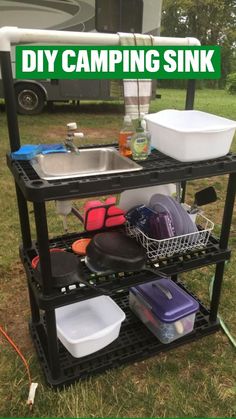 a metal sink sitting on top of a black shelf next to a camper trailer