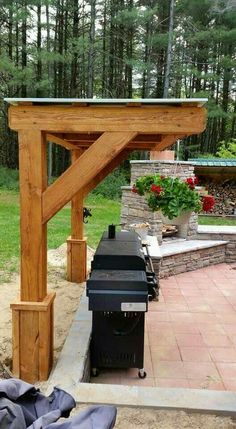 an outdoor bbq with a grill in the middle