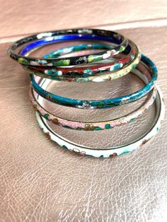 A beautiful selection of cloisonné bangles!  All bangles are sold separately!  these are all Vintage and some are even antique so they have natural science of wear.  please see attached pictures for sizing on each bangle.  these Bengals are well-made, but banging them against something very hard could cause them to break.  as with most vintage items, they should not be worn while doing very active activities like running jogging, working out swimming or any athletics as well as cooking, like sli Multicolor Enamel Bangle Bracelets, Vintage Multicolor Enamel Bangle, Traditional Hand Painted Bangle Bracelet, Traditional Handmade Enamel Bangle, Handmade Vintage Enamel Bangle, Vintage Handmade Enamel Bangle, Handmade Enamel Bangle, Handmade Multicolor Enamel Bracelets, Vintage Round Enamel Bangle