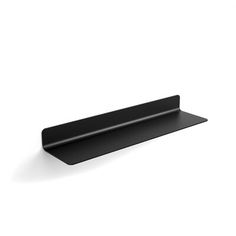 a black shelf sitting on top of a white wall