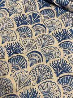 a blue and white fabric with an intricate design