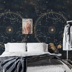 a bed room with a neatly made bed and a star map on the wall behind it