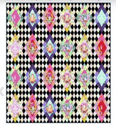 a black and white checkered quilt with colorful designs