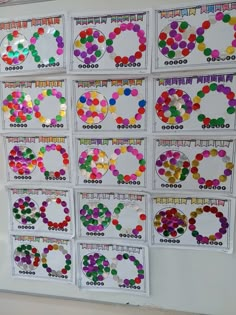 a bulletin board with different colored circles and numbers on it's sides, hanging from the wall