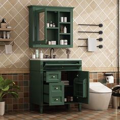 a bathroom with green cabinets and a white toilet