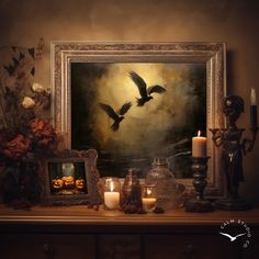 two birds flying over a painting with candles and other items on a table next to it