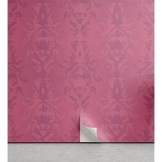 a pink wallpaper with a white corner in the middle and an ornate pattern on it