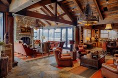 a living room filled with lots of furniture and a fire place next to a window