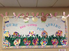 an egg - cied bulletin board is decorated with easter bunnies and bunny ears