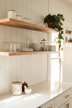 the kitchen counter is clean and ready to be used for dishes, cups, and mugs