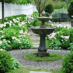 a fountain in the middle of a garden