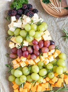 a christmas tree made out of cheese and grapes