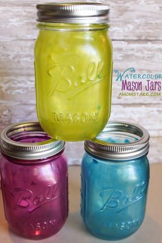 three mason jars are sitting next to each other