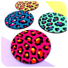 three coasters with different colors and designs on the top one has an animal print pattern