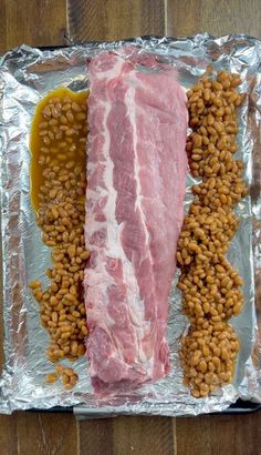 some meat and beans are on tin foil