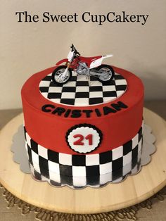 a red and black cake with a motorcycle on top