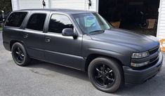 a gray truck parked in front of a garage