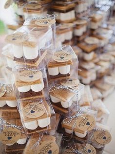 there are many cookies in plastic bags on the table and one is stacked high with tags