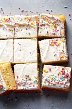 cake with white frosting and sprinkles cut into squares