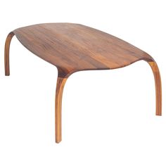 a wooden table that is made out of wood and has an oval shaped top with curved legs