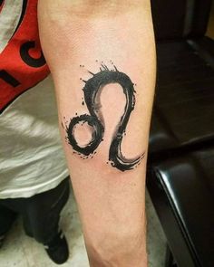 a person with a tattoo on their arm and the letter s is painted in black ink