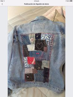 the back of a jean jacket with patchwork on it