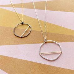 We love how the OPTIMIST necklace has a carefree, positive vibe about it!Each OPTIMIST circle starts out as a piece of sterling silver wire that we hand shape into an organic circle. It is then hammered and reshaped - no two are exactly alike! We then add a contrasting piece of hammered wire asymmetrically.Each pendant comes on our signature dainty cable chain. Necklace Details all components are sterling silver and gold filled available in 16" & 18" (recommended) chain lengths pendant measures Silver Circle Necklace, Modern Everyday Necklace With Open Circle, Minimalist Full Circle Necklace With Delicate Chain, Handmade Everyday Circle Necklace, Minimalist Round Brass Charm Necklace, Everyday Minimalist Hammered Charm Necklaces, Minimalist Adjustable Circle Necklace, Everyday Circular Brass Necklace, Delicate Chain Necklace For Everyday