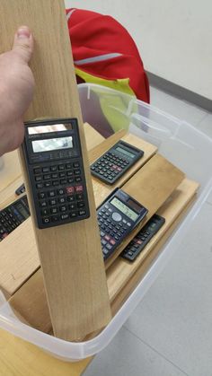 there is a calculator on top of a table with three other calculators