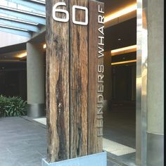 the entrance to an office building with wood and metal letters that read 60 fifth avenue