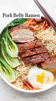 a bowl filled with noodles, meat and vegetables next to chopsticks on a white surface